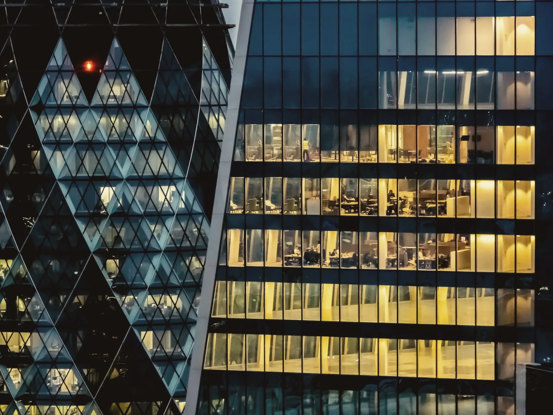 Office floors lit up at dusk in the City of London
